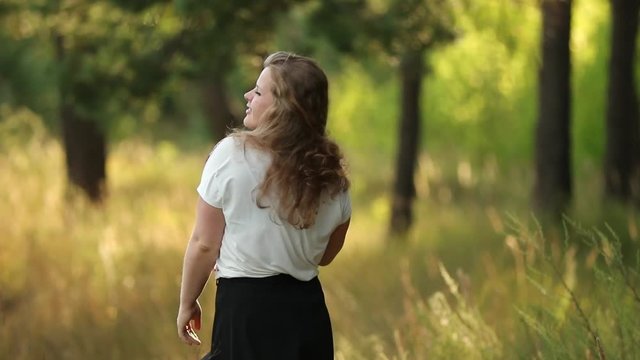 Single Young Pretty Plus Size Caucasian Happy Smiling Laughing Girl Woman In White T-shirt, Dancing In Summer Green Forest. Fun Enjoy Outdoor Summer Nature. Slo-mo, Slow Motion, Slo-mo, Slow-mo