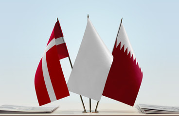 Flags of Denmark and Qatar with a white flag in the middle