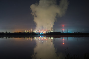 Obraz premium The factory is working in night. Have light and smoke and shadow