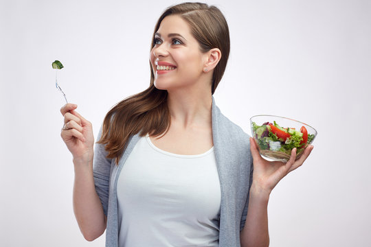 lifestyle isolated portrait of smiling woman holding green salad