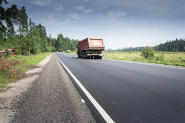 Fototapeta premium Truck transportation on the road at sunset