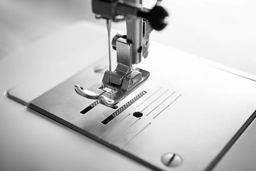 Presser foot and needle of modern sewing machine, closeup