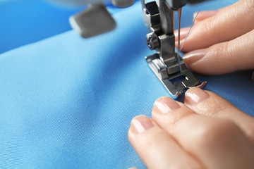 Woman threading sewing machine, closeup