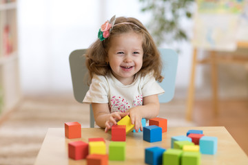 child 2 years ago playing wooden toys at home or kindergarten