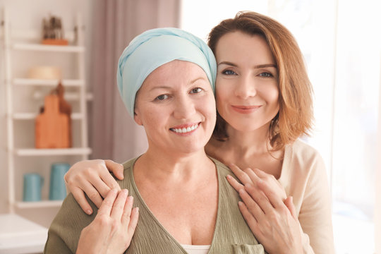 Young woman visiting her mother with cancer indoors