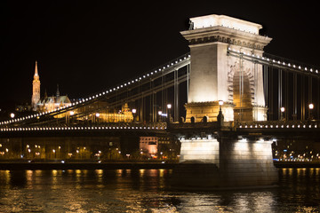 Chain bridge support against Matthias church at night, Budapest