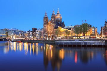 Fototapeta na wymiar Selective focus on St Nicolas Church in Amsterdam at twilight, Netherlands