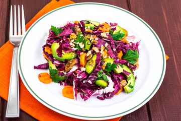 Healthy food. Salad of fresh vegetables with avocados and nuts