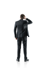 Rear view businessman scratching head, isolated