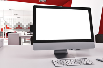 Blank computer screen in red and white office