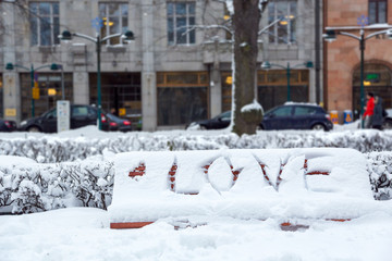 Love writing on snow. Winter romantic scene outdoors in the park.  Valentine's Day celebration concept.