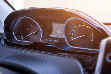 Car speedometer close up. Modern car interior with blue led light.