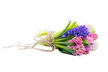 Lilac, blue, pink, raspberry hyacinths in a small, low bouquet, tied with a rope. A holiday, a gift for a woman. Smart. Side view. Isolated