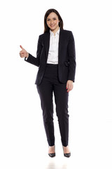 Smiling businesswoman with thumbs up standing on white background