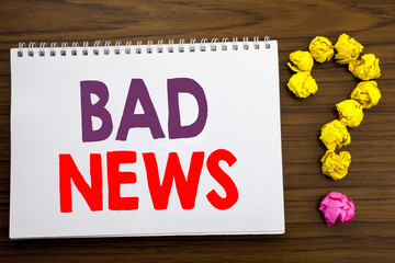 Conceptual hand writing caption inspiration showing Bad News. Business concept for Failure Media Newspaper written on notepad note paper on the wooden background with question mark.