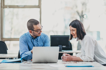 Two colleagues monitoring project progress