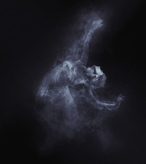 Dancer from smoke on the dark background