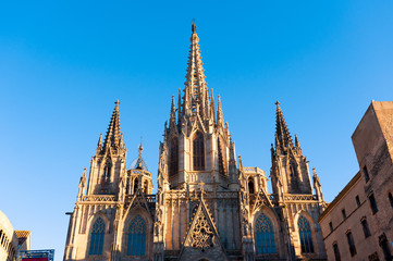 Fototapeta na wymiar front view of barcelona cathedral facade during summer evening at sunset with blue sky