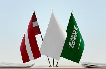 Fototapeta premium Flags of Latvia and Saudi Arabia with a white flag in the middle