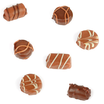 Assortment of chocolate candies isolated on white background.