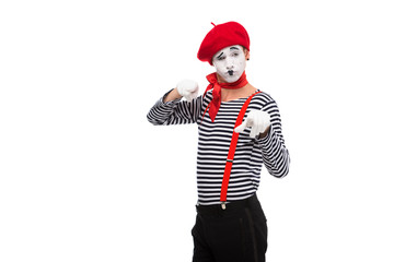 grimacing mime pointing on camera isolated on white