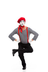 funny mime performing on one leg isolated on white