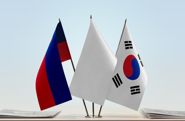 Flags of Liechtenstein and South Korea with a white flag in the middle