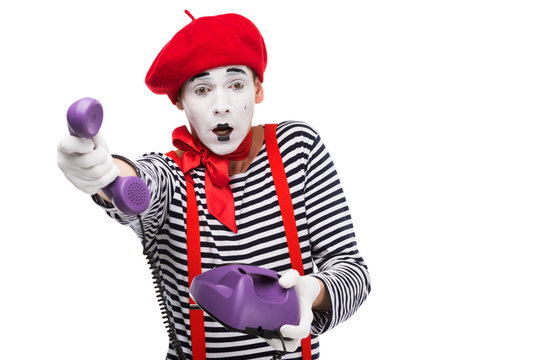 shocked mime giving ultra violet retro stationary telephone isolated on white
