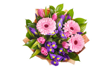 Bouquet of pink gerberas, violet irises and pink, crimson tulips in a package of paper. A holiday,...