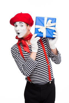 cheerful mime holding gift box isolated on white
