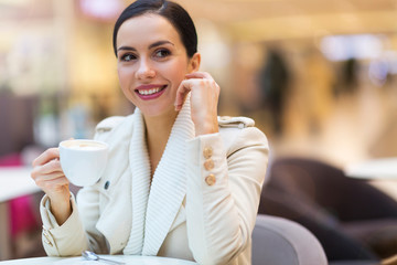 Woman drinking coffee in cafe

