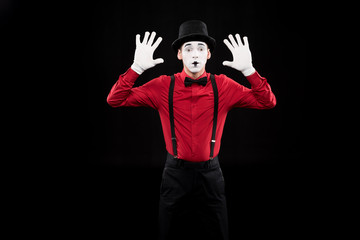 mime with hands up isolated on black
