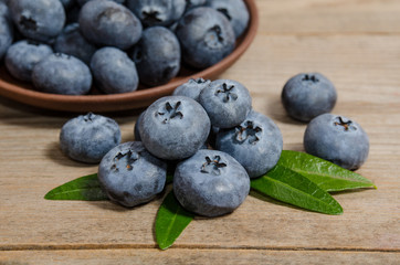 blueberries in a plate  and on wooden background
