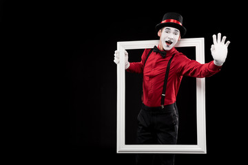 happy mime waving hand from frame isolated on black
