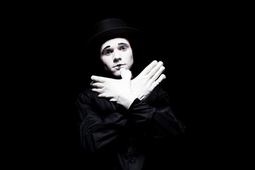 mime showing bird with hands isolated on black