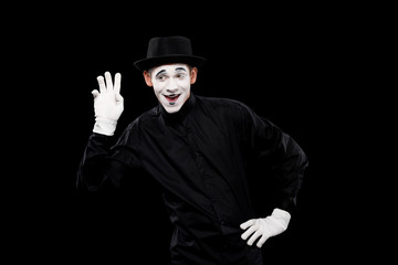 Fototapeta na wymiar happy mime waving hand isolated on black