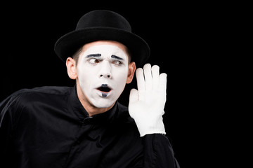 mime overhearing something isolated on black