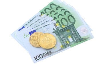 Golden Bitcoins close-up on euro currency background.