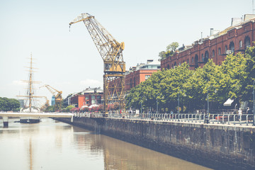 Puerto Madero Waterfront district. Modern skyline at sunny day. View of Puente de la Mujer .