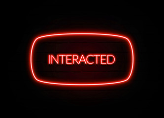 Interacted neon sign on brick wall background.