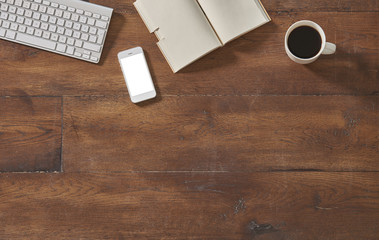 keyboard smartphone notebook and coffee on the decorative wood table
