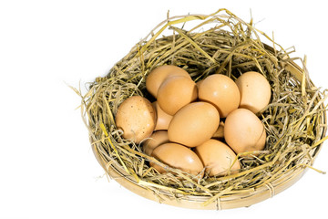 Group of eggs with straw in a bamboo basket isolated on white background.