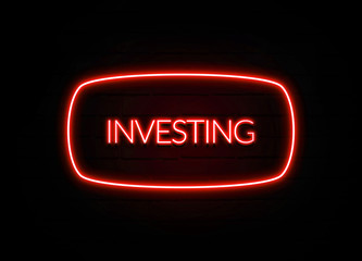 Investing neon sign on brick wall background.