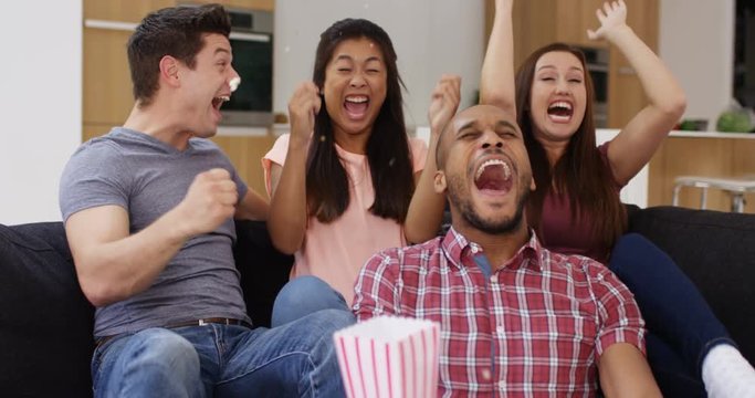 4k, Group of young friends throw popcorn on themselves while celebrating watching TV