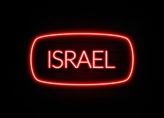 Israel neon sign on brick wall background.