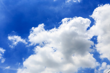 Naklejka na ściany i meble Cloud over beautiful blue sky. Copy space. Background.