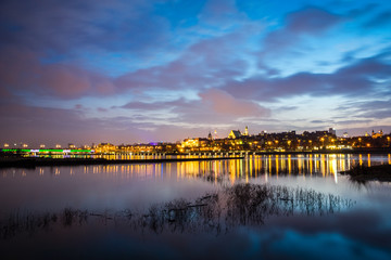 Night view on the old town and Vistula river in Warsaw, Poland