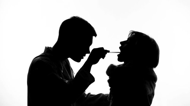Medical worker checking throat of sick woman, epidemic virus, flu sickness