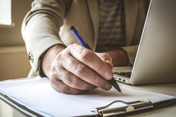 Fototapeta premium Focus of businessman hand sing papers.