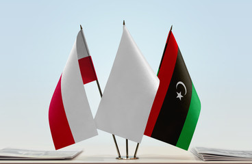 Flags of Poland and Libya with a white flag in the middle